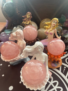 Colorful mermaid stand and rose quartz sphere