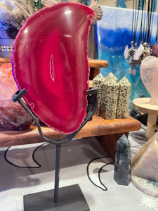 Pink agate slab in stand